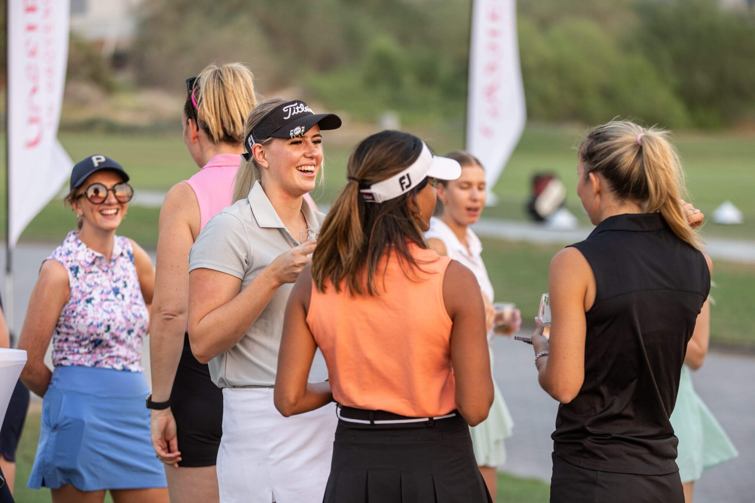 A woman golfer teeing off at a UAE golf course